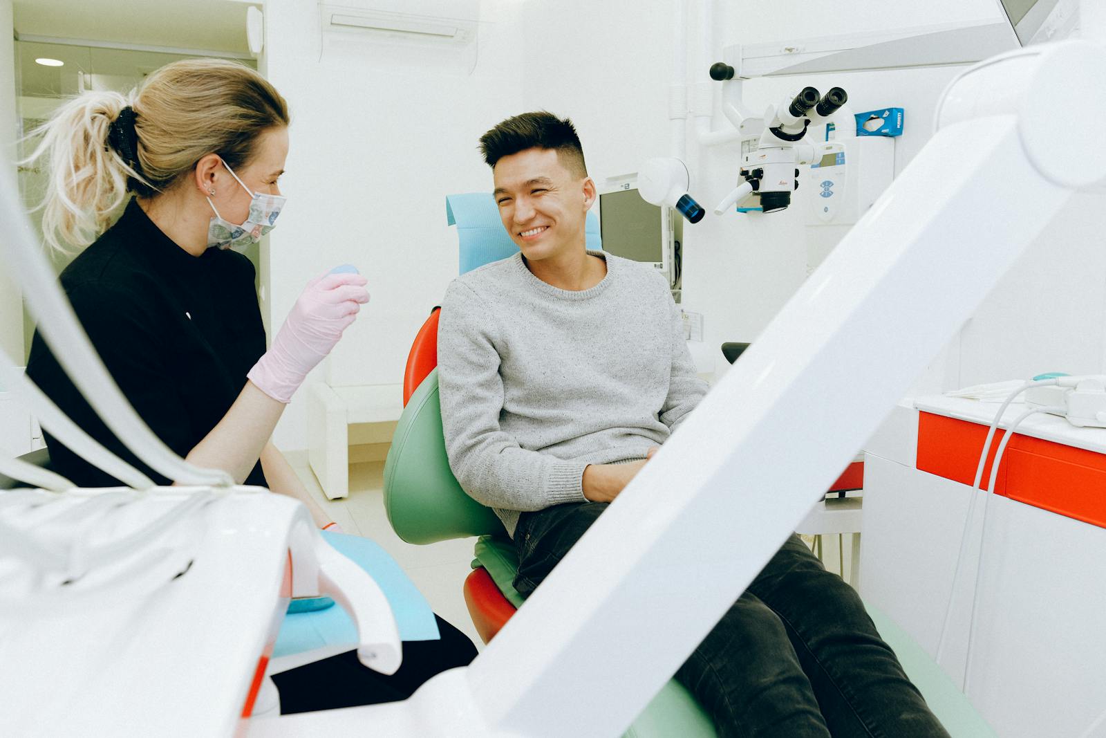 Dental professional consulting with a patient in a clinical setting